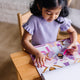 Child playing with Melissa & Doug Reusable Sticker Pad Dress-Up fashion stickers
